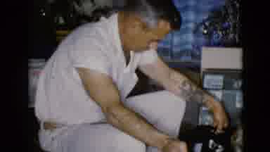 Clarksdale Arizona USA (1968): An Older Man In His Front Room Opening A Present In