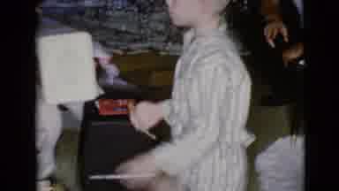 Clarksdale Arizona USA (1968): A Young Boy Unwraps A Christmas Present With His