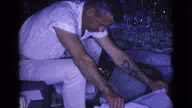 Clarksdale Arizona USA (1968): A Man Opening Up A Present