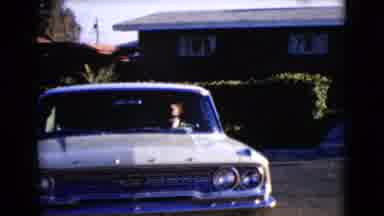 Clarksdale Arizona USA (1968): Big White Car With Two People Reverse Out Of A