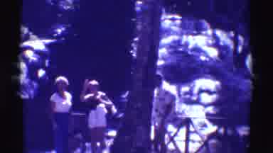Mauna Ulu Hawaii (1971): Three People In Front Of A Waterfall Smile And Wave