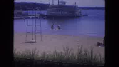 Mississippi River USA (1972): People Playing In The Ocean Near A Big Boat