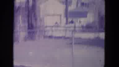Racine Wisconsin USA (1972): Dog Sitting Down In Fenced In Area Outside Of A House