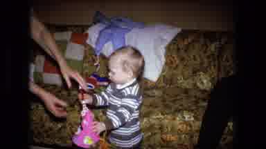 Fort Wayne Indiana (1973): Older Lady Helps Young Child With Party Favors At A