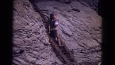 Gila National Forest New Mexico (1973): Man Walks With Child On His Lap At Cave