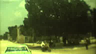 Mexico City (1973): Person Wearing White Shirt Rides Red And Tan Motorbike On A