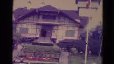 Orlando Florida USA-1974: Camera Panning Of A Swiss-Style House And Flags