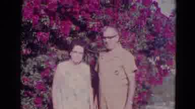Orlando Florida USA (1974): Husband Picking Flowers While Wife Stares Directly