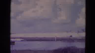 Orlando Florida USA (1974): Lake Beach Sky Bridge Clouds Water Grass Airplane