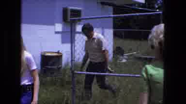 Fort Wayne Indiana (1974): Scene Of A Man Walking By A Fence Transitions To An