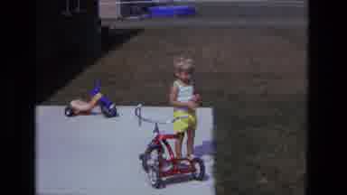 California USA-1975: Boy On Bike Tries To Ride Bike And Hurts His Finger