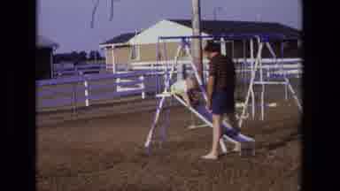 California USA (1975): Playing With Dad In The Backyard Swing Set During Summer Is