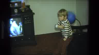 California USA (1975): A Little Boy Is Playing With Blue Balloon Near To A