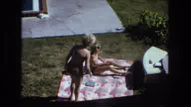 Fort Wayne Indiana (1974): Two Women In Bikinis Outside On A Large Mat Are