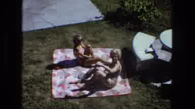 Fort Wayne Indiana (1974): Two Women Applying Sunscreen Sitting On A Blanket On