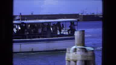 Fort Wayne Indiana (1974): A Ferry Boat Full Of People Crosses A Lake As It Gets