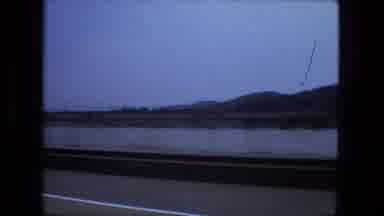 Fort Wayne Indiana (1974): Passing View Of Mountains And Lake On A Cloudy Day