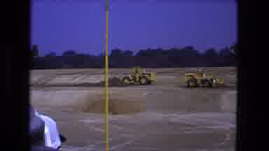 Fort Wayne Indiana (1974): Two Front Loader Trucks Working On A Construction Site