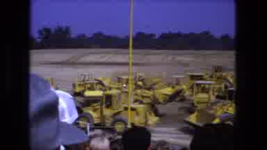 Fort Wayne Indiana-1974: A Bunch Of Front End Loaders All Moving Around At A Construction Site