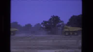 Fort Wayne Indiana (1974): Massive Dump Trucks Driving Dirt Road