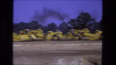 Fort Wayne Indiana (1974): A Line Of Earth Moving Equipment Stretches Across A