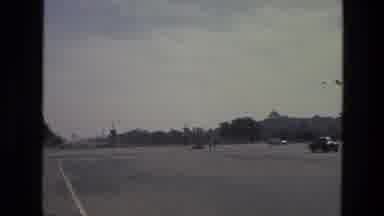 India (1974): Uniformed Man Walking Past Row Of National Flags In Large Square