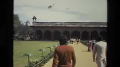 India (1974): Walking Swiftly Down The Long Concrete Walkway To Enter A Wide