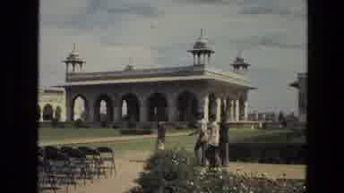 India (1974): A Group Of People Walking Outside Near An Old Temple Then A Shot
