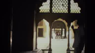 India (1974): Man Points At The Child Walking Over From The Other Building
