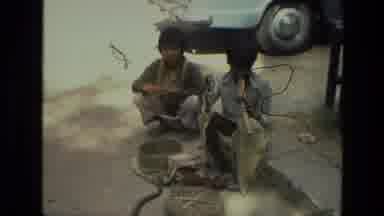 India (1974): Kids Sitting Outside Playing