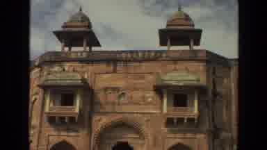 India (1974): An Person Is Seen Walking Outside An Old Arabesque Building