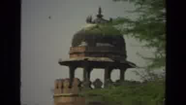 INDIA-1974: Handheld Cinematic Footage Of Rural Building With Tree Overhanging