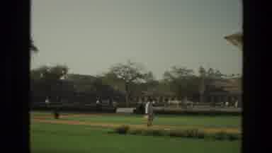 India (1974): A Barrack Type Of Building With A Big Garden And People Moving