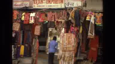 India (1974): She Is Putting Dresses Away In Her Store Before She Leaves