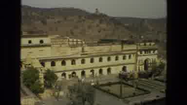 India (1974): Large Cream Colored Resort Hotel Nestled Between Two Mountain Ranges