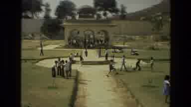 India (1974): Outdoor Area With Many Children Playing On The Grass On A Sunny Day