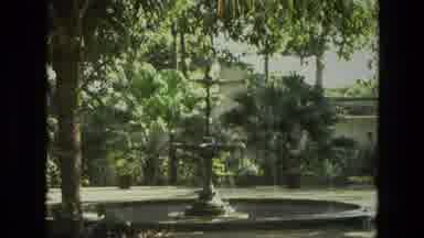 India (1974): Old Footage Of A Fountain In A Park Surrounded By Trees