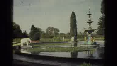 India (1974): A Tall Created Water Fountain Surrounded By Trees In A Beautiful