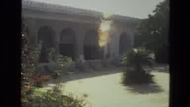 INDIA-1974: People Walking Through Courtyard To Historic White Mausoleum