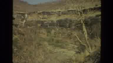 India (1974): Dry Arid Land Off A Bridge Surrounded By Rock Faces And Dying Trees