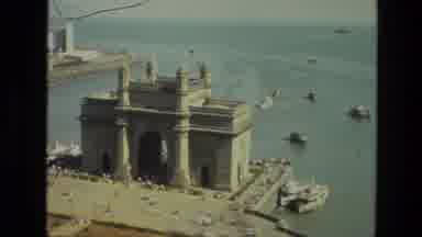 INDIA-1974: A Very Tall And White Concrete Building Surrounded By Water On A