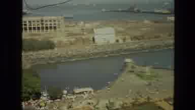 India (1974): Shots From Above Of Harbor-Like Body Of Water With Dozen Of People