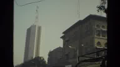 India (1974): Cars Rustling By A Beautiful Busy Town With Old Historic Buildings