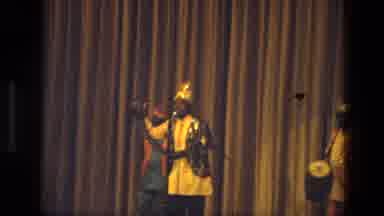 India (1974): Man In Fancy Dress Address The Audience As He Holds Up A Long Snake