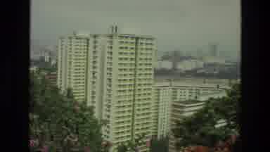 India (1974): Extremely Off-White Tall Building Surrounded By Other Shorter