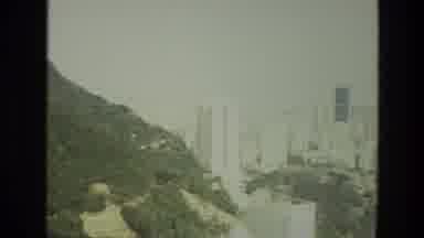 India (1974): Camera Pans Across A Mountain And A City With A Park