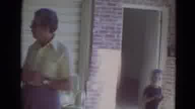 Lincoln Nebraska (1974): Men Women And Children All Standing Outside Of A Home