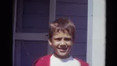 Lincoln Nebraska (1974): Young Boy Waving In A Red And White Shirt Smiling Happily