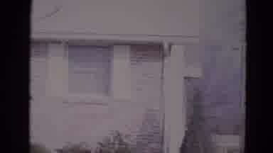 Lincoln Nebraska (1974): A Group Of People Are Standing Outside Of A Suburban