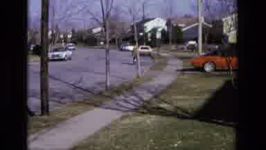 California USA (1975): A Man Riding His Bike Down The Street